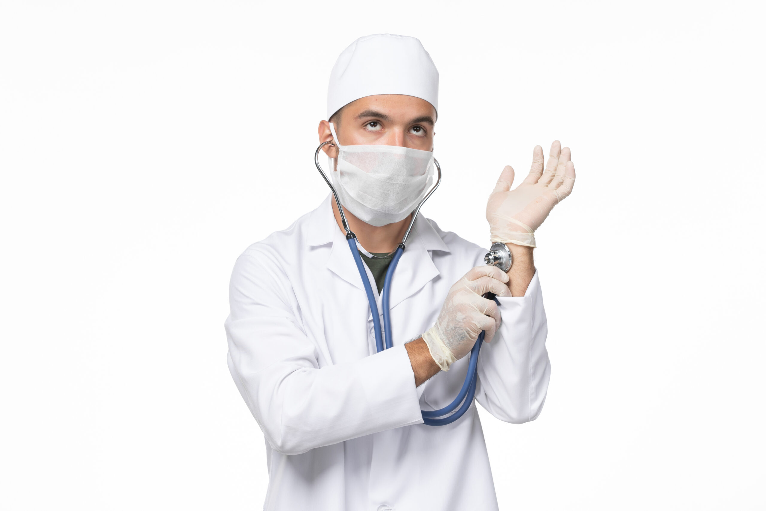 front-view-male-doctor-medical-suit-wearing-mask-due-covid-checking-his-pulse-white-wall-illness-covid-pandemic-virus-disease